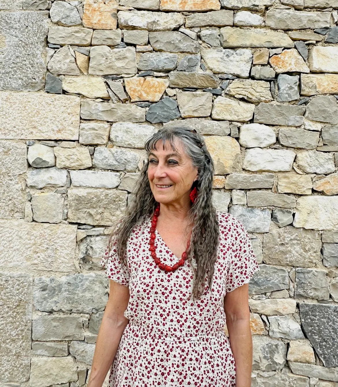 Friederike Bach standing in front of a stone wall